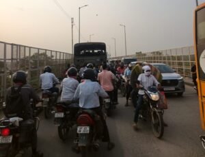Head-on collision between two cars on Rajghat Bridge; commuters stranded in a massive traffic jam.