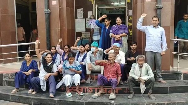 Sanitation workers at Ayodhya District Hospital go on strike over non-payment of salaries; stage a protest outside the emergency ward.